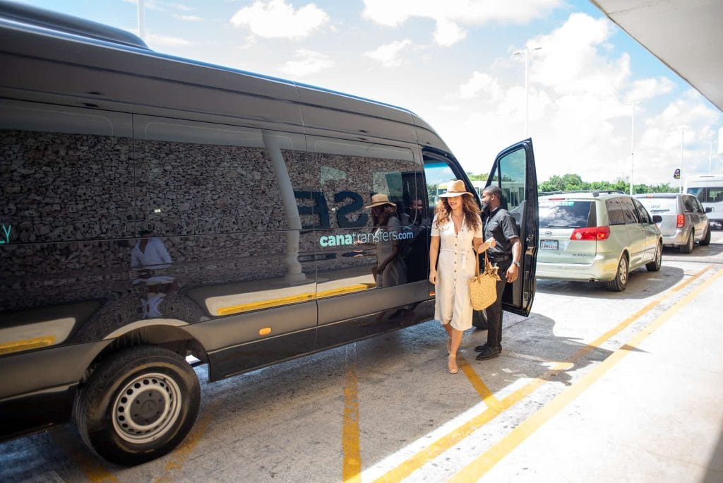 Black Cana Transfers van with a passenger at the open door after an airport transfer in Punta Cana